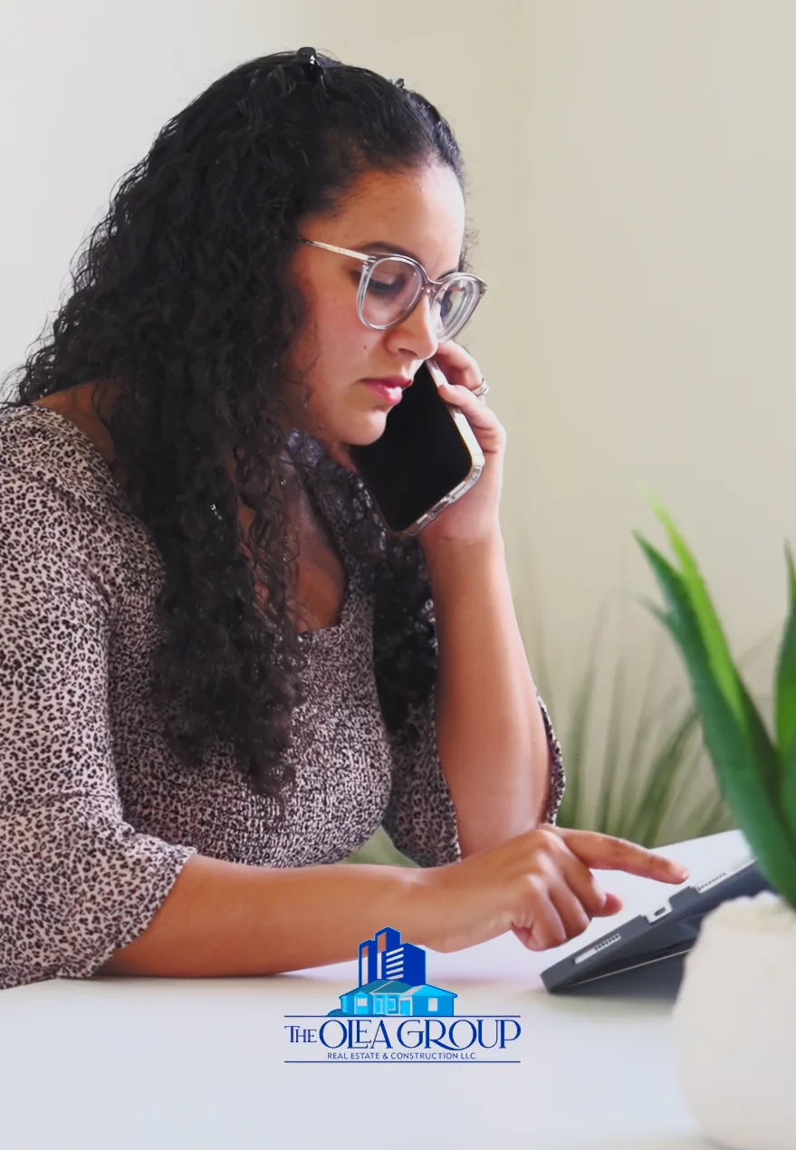 Olea agent on a phone call while working at a tablet