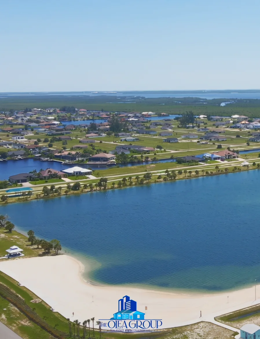 Aerial view of a waterfront neighborhood, canals, and a sandy beach
